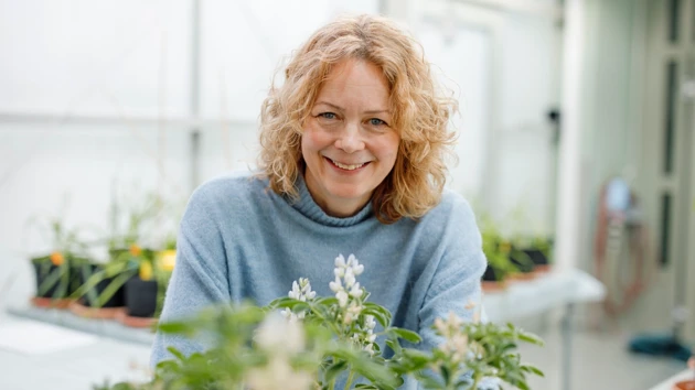 Åsa Strand standing by some plants