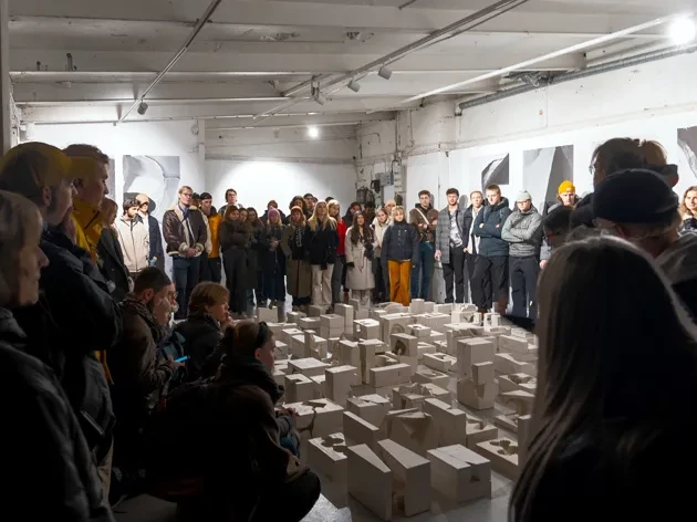 Image from public exhibition with people standing around landscape model